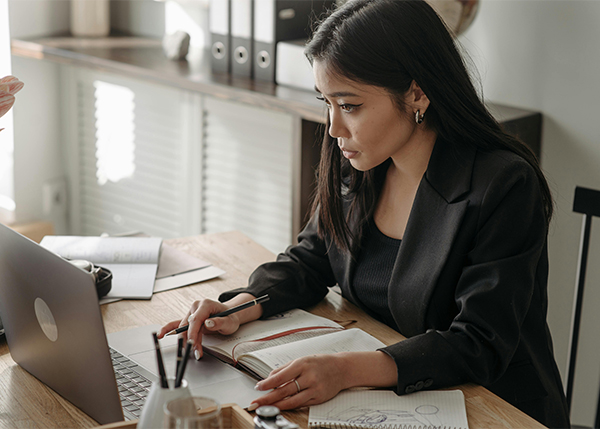 woman using laptop for work while at home